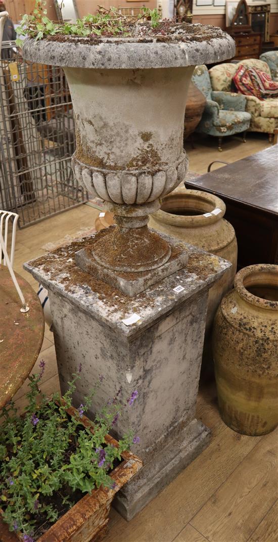 A reconstituted stone Campana garden urn, on square pedestal, H.161cm